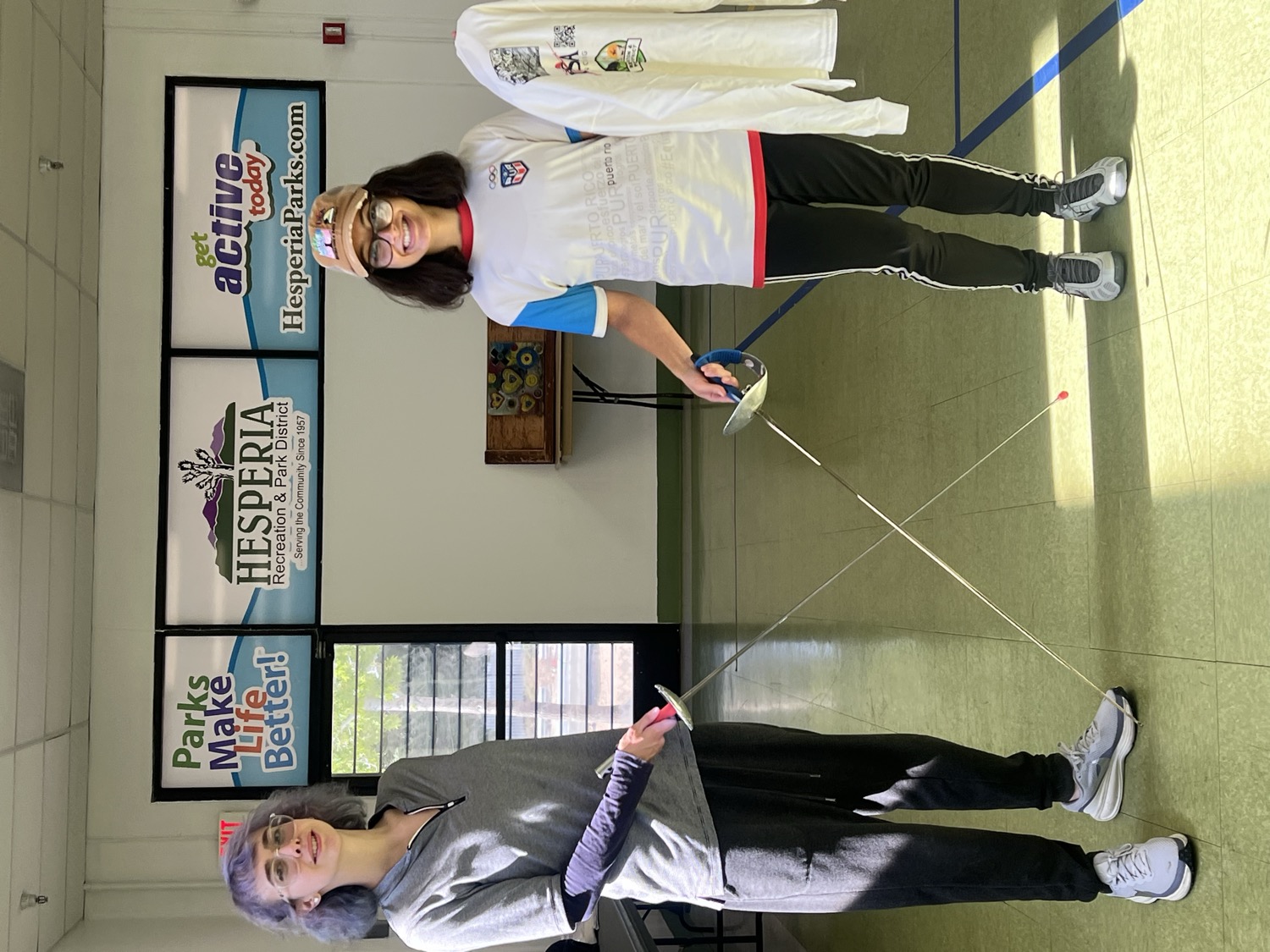 Coach and student showing off the club jersey