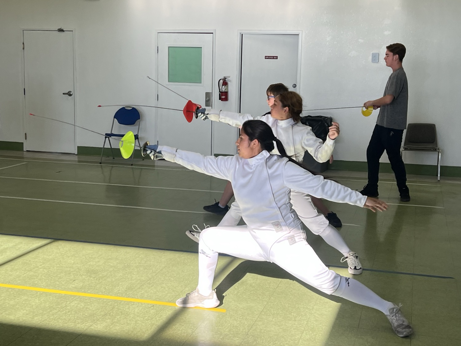 Group of fencers training and lunging together