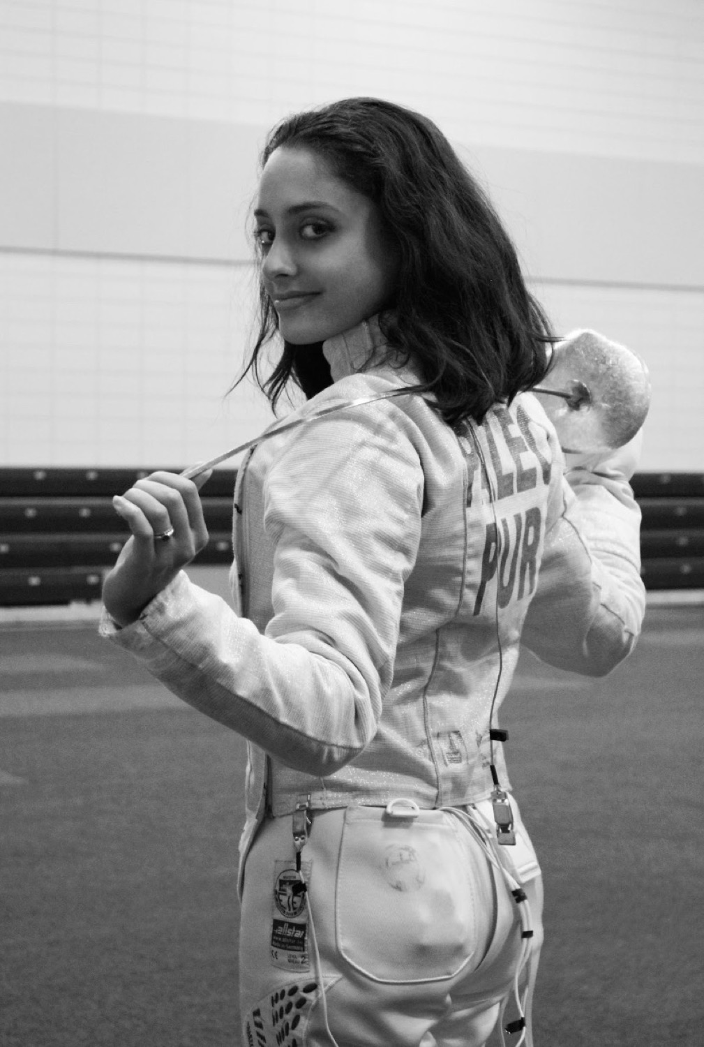 Fencer posing with a saber over the shoulder