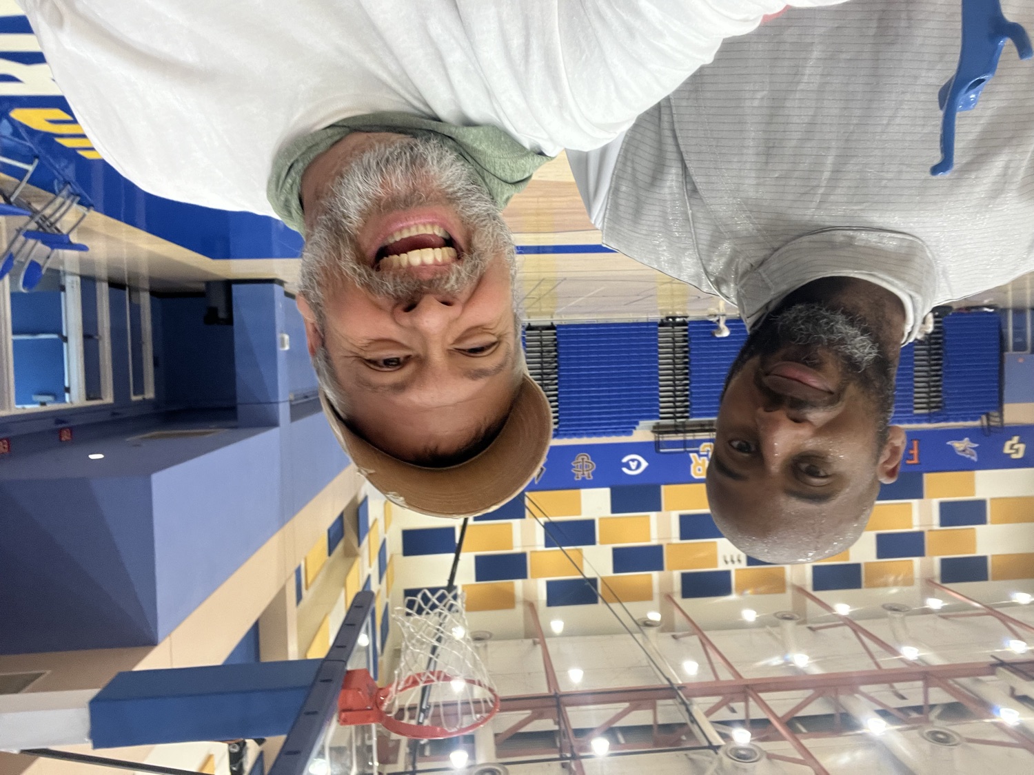 Two Mojave Fencing coaches smiling together in the gym