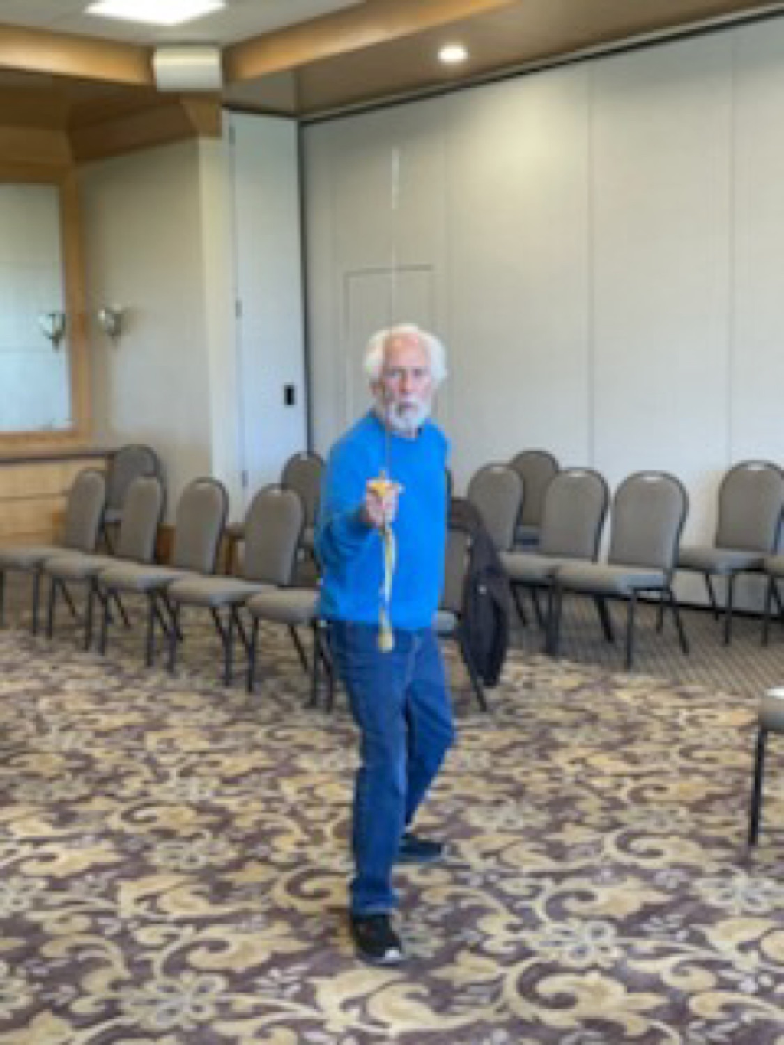 A club member holding a foil in an en garde stance