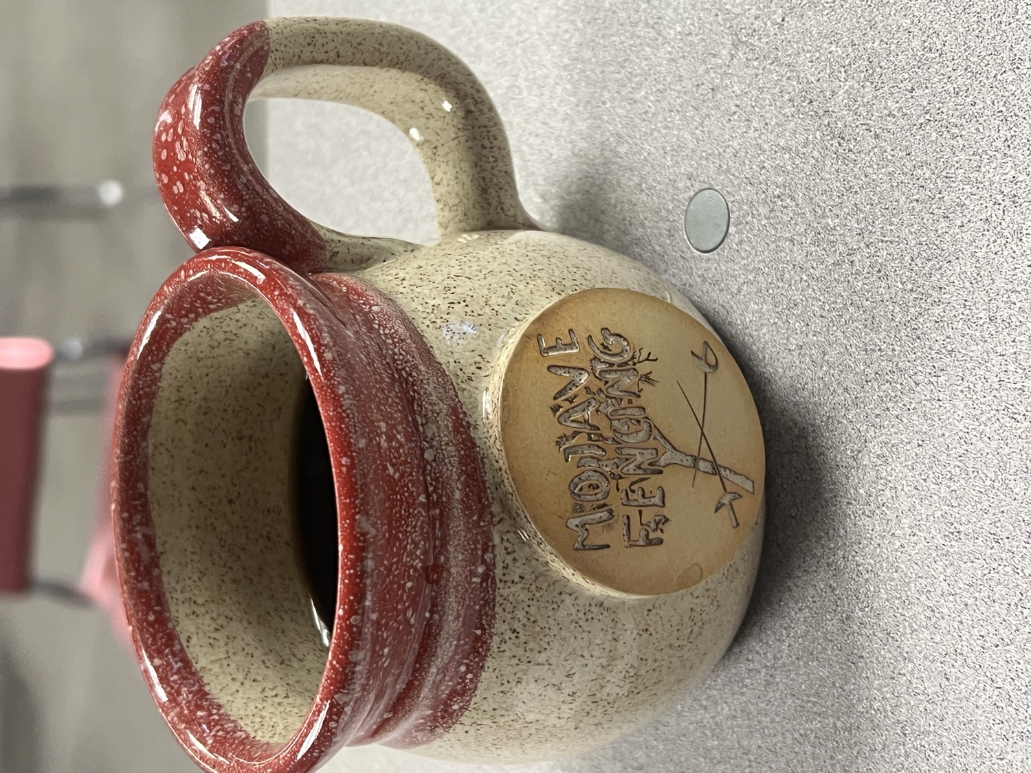 Handmade speckled stoneware mug with a Mojave Fencing carved medallion